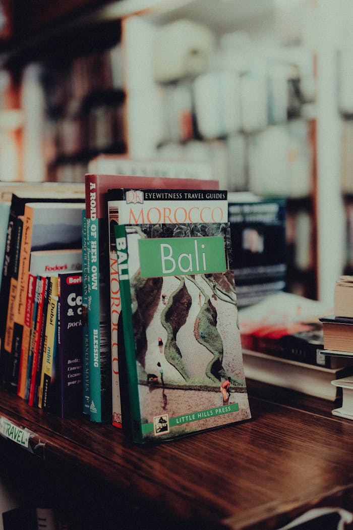 A cozy bookstore shelf displaying travel guidebooks from various destinations.